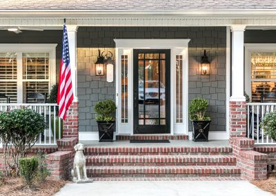 front porch showing door and the American flag